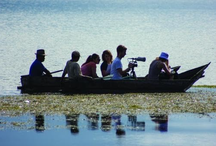 documentary-voice-vision A group of people in a wooden boat.