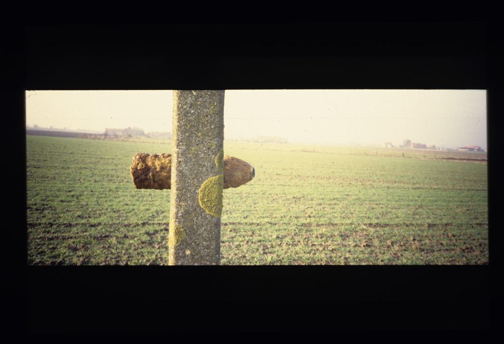 A photo of an artillery shell in a post from WWI in the Belgian countryside.